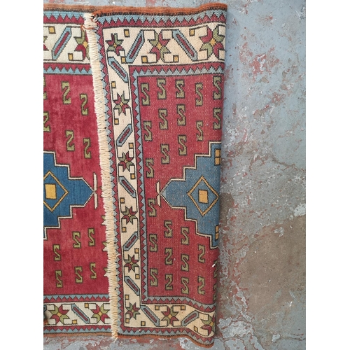 441A - A Persian style red rug - approx. 183cm x 133cm