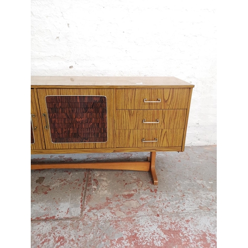 442 - A mid 20th century teak and rosewood effect sideboard with three cupboard doors and three drawers - ... 