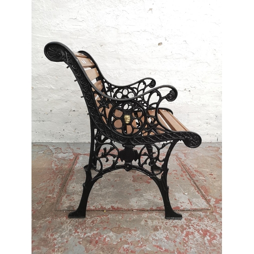 A cast iron and wooden slatted garden armchair - approx. 70cm high x ...