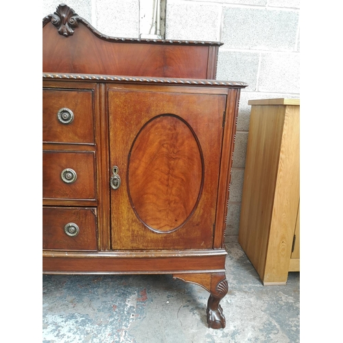 461 - A Georgian style mahogany bow fronted sideboard with carved acanthus leaf gallery back, two outer cu... 