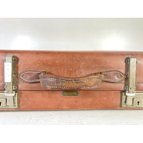 353 - A vintage Revelation brown leather suitcase