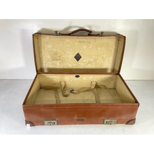 353 - A vintage Revelation brown leather suitcase