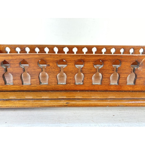 354 - An early 20th century Gothic revival oak galleried tray with brass bun feet - approx. 7cm high x 47c... 