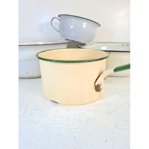 185A - Four pieces of mid 20th century enamel kitchenware, two saucepans and two bowls - largest approx. 40... 