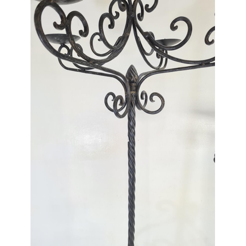 185D - Three wrought iron candle holders - largest approx. 93cm high