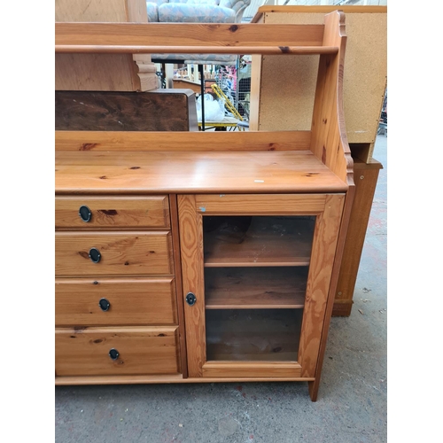 408A - A modern pine sideboard with two glazed doors, four central doors and upper shelf - approx. 124cm hi... 