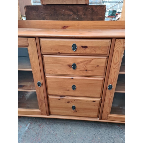 408A - A modern pine sideboard with two glazed doors, four central doors and upper shelf - approx. 124cm hi... 