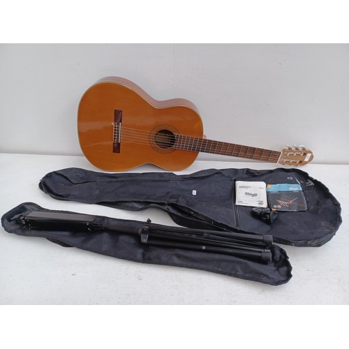 566 - A cased Japanese Hokada 3162 full size nylon strung classical guitar with cased music stand, Eno ele... 