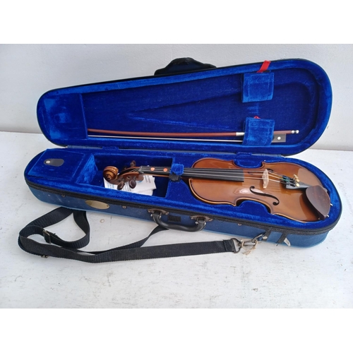 570 - A cased Stentor Student I ¼ size child's violin with bow, rosin and shoulder rest