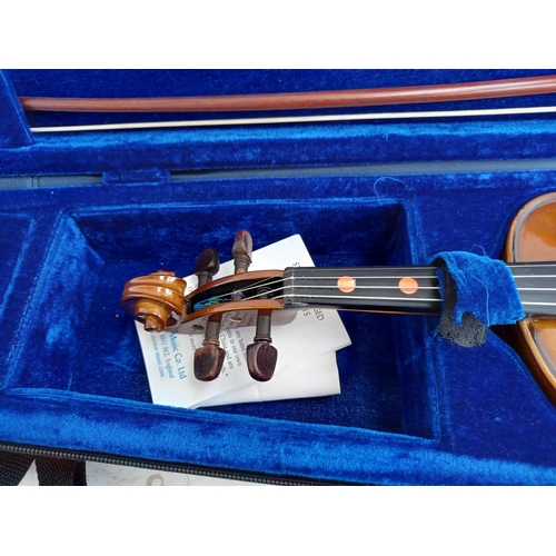 570 - A cased Stentor Student I ¼ size child's violin with bow, rosin and shoulder rest