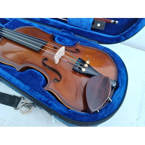 570 - A cased Stentor Student I ¼ size child's violin with bow, rosin and shoulder rest