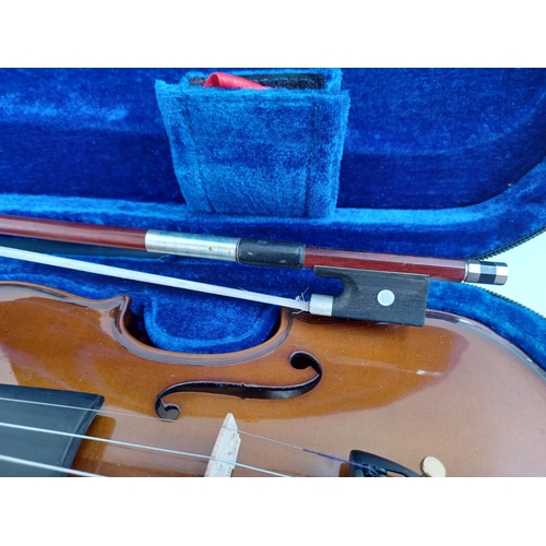 570 - A cased Stentor Student I ¼ size child's violin with bow, rosin and shoulder rest