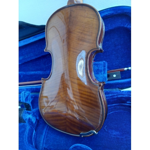 570 - A cased Stentor Student I ¼ size child's violin with bow, rosin and shoulder rest