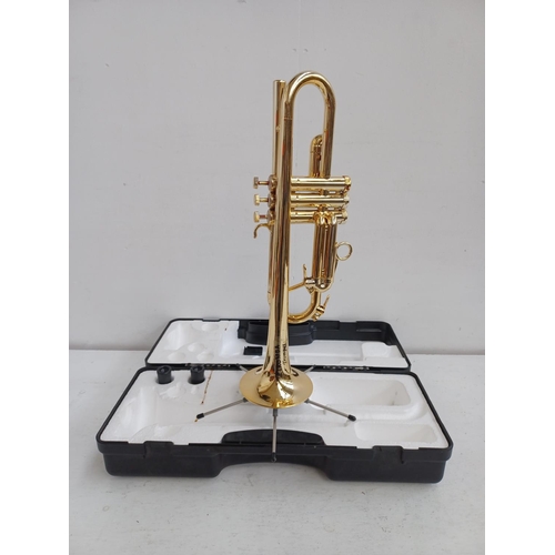 573 - A cased Tromba plastic trumpet with two mouth pieces and folding stand