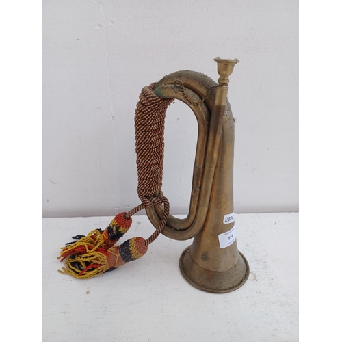 574 - A vintage brass bugle with tri-colour cord