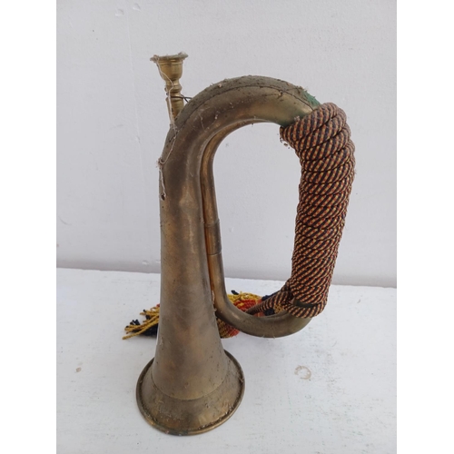 574 - A vintage brass bugle with tri-colour cord