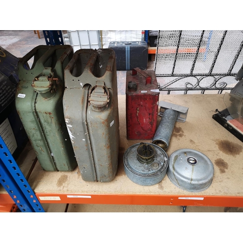 653 - Four pieces of vintage metalware comprising red painted petrol can with brass top, two 20L jerry can... 