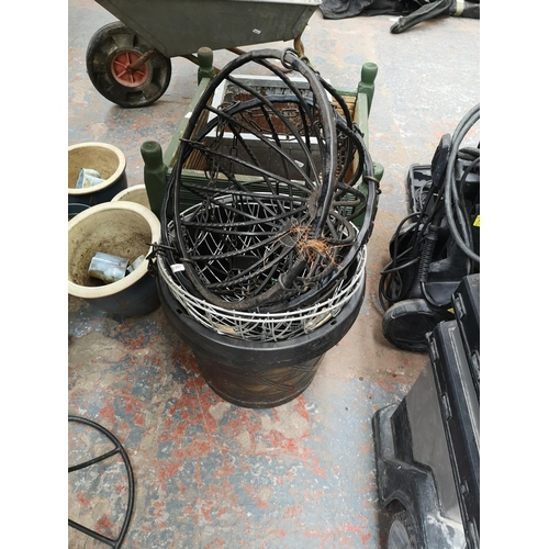 658 - A large collection of assorted garden equipment and accessories to include galvanised wheelbarrow, b... 