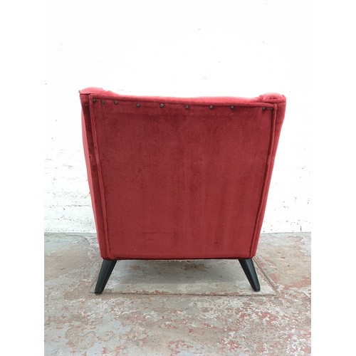 393 - A mid 20th century G Plan red upholstered armchair with ebonised splayed supports - approx. 74cm hig... 