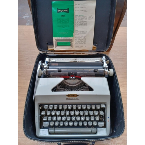 614 - A cased Olympia SM9 portable typewriter