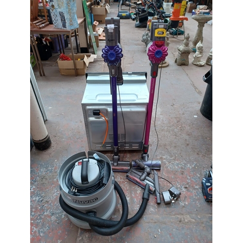 619 - Three vacuum cleaners, one Dyson V6 upright cordless bagless with charger and attachments, one Dyson... 