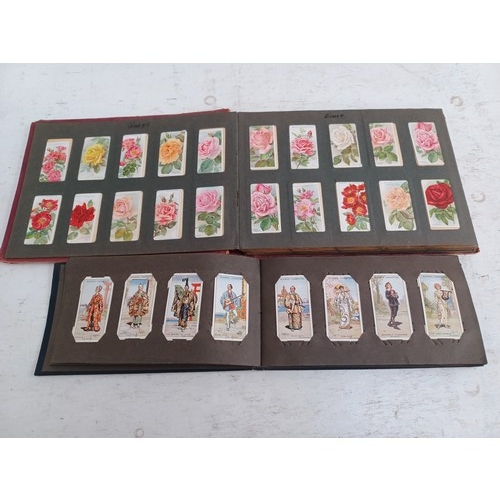 295 - A collection of vintage cigarette card albums to include Wills's Roses, Garden Life, Aviation, Crick... 