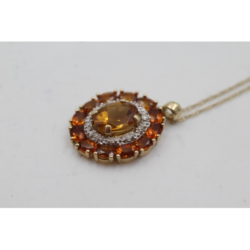 1002 - A 9ct gold citrine and diamond double halo pendant necklace - approx. gross weight 3.3 grams