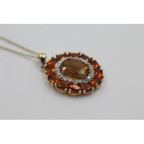 1002 - A 9ct gold citrine and diamond double halo pendant necklace - approx. gross weight 3.3 grams