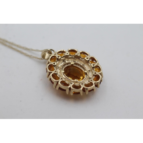 1002 - A 9ct gold citrine and diamond double halo pendant necklace - approx. gross weight 3.3 grams