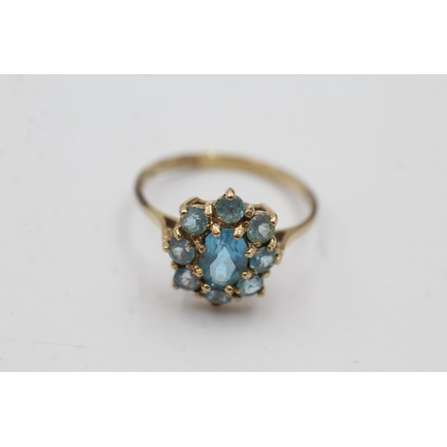 1006 - A 9ct gold blue topaz cluster dress ring, size Q½  - approx. gross weight 2.3 grams