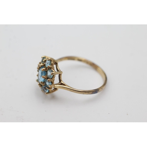 1006 - A 9ct gold blue topaz cluster dress ring, size Q½  - approx. gross weight 2.3 grams