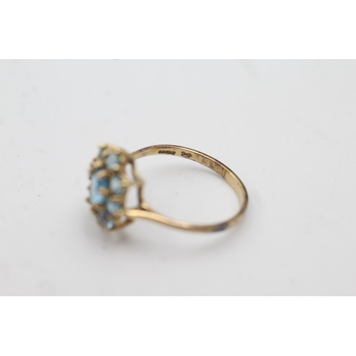 1006 - A 9ct gold blue topaz cluster dress ring, size Q½  - approx. gross weight 2.3 grams