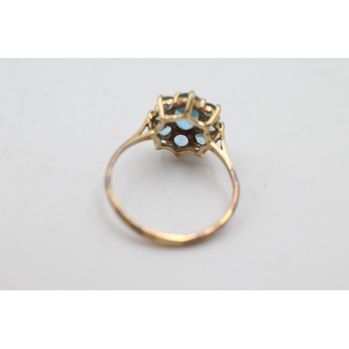 1006 - A 9ct gold blue topaz cluster dress ring, size Q½  - approx. gross weight 2.3 grams