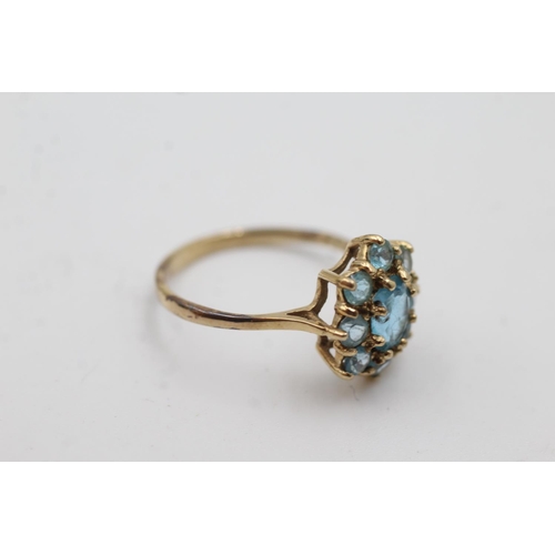 1006 - A 9ct gold blue topaz cluster dress ring, size Q½  - approx. gross weight 2.3 grams