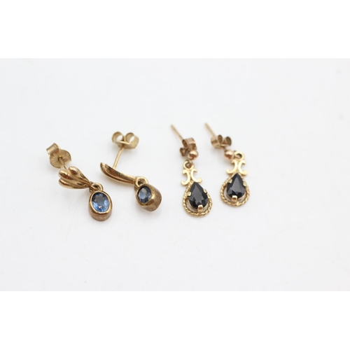 1007 - Two pairs of 9ct gold and sapphire drop earrings - approx. gross weight 2.9 grams