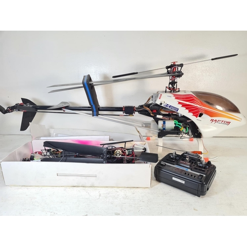 102 - A Raptor 30 class remote control helicopter and a Spy Hawk remote control helicopter with two remote... 