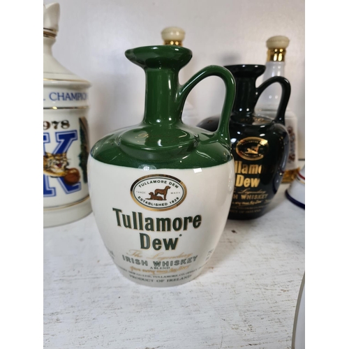 37 - A collection of assorted ceramic jugs and decanters to include Wade Tullamore Dew Irish Whiskey jug,... 