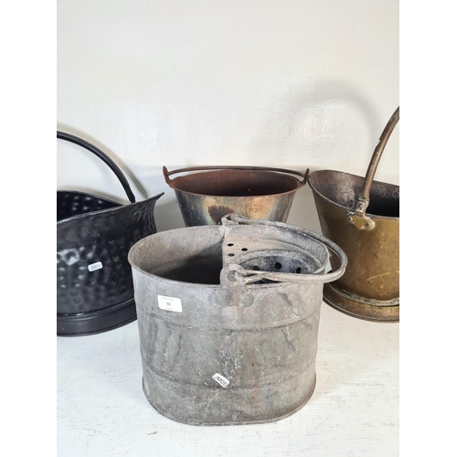 50 - Four assorted metal buckets to include brass coal bucket, galvanised mop bucket etc.