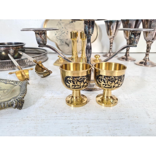 62 - A collection of metalware to include four Valero silver plated goblets, silver plated three branch c... 