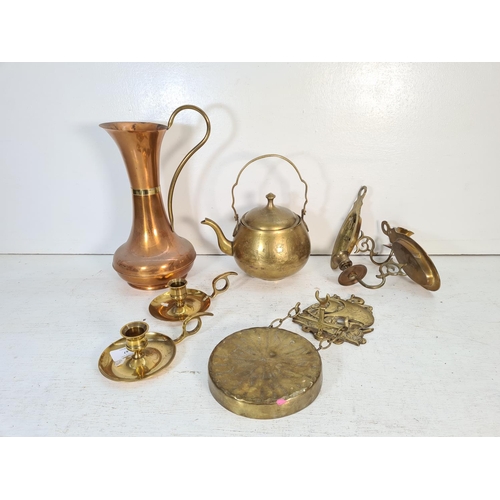 67 - A collection of brass and copper ware to include kettle, wall sconces, chamber sticks etc.