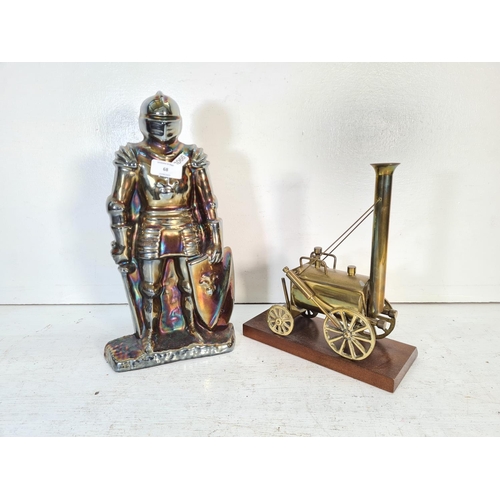 68 - Two items, one cast metal novelty knight companion set and one brass model of Stevenson's Rocket on ... 