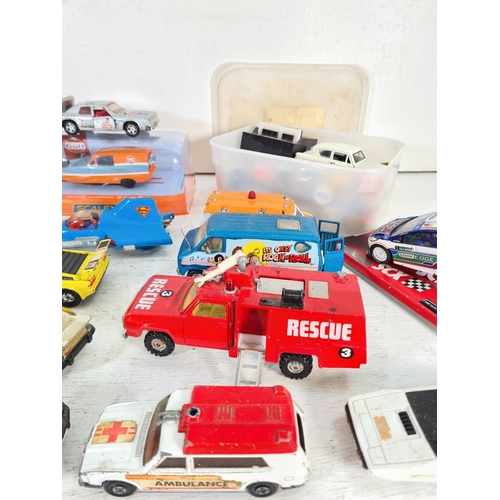 74 - A collection of assorted model vehicles to include Saico Ford Anglia, SCX Ford Fiesta WRC, boxed Sca... 