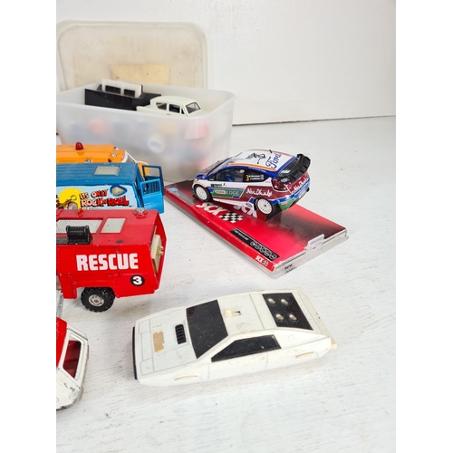 74 - A collection of assorted model vehicles to include Saico Ford Anglia, SCX Ford Fiesta WRC, boxed Sca... 