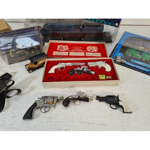 88 - A collection of assorted toys to include boxed BCM The Outlaw miniature antique firearms cap gun set... 