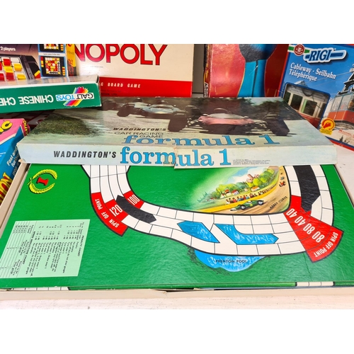 90 - A collection of assorted boxed toys and games to include Monopoly, Chinese chess, Cover Up, Take The... 