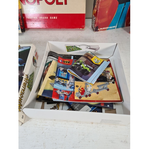 90 - A collection of assorted boxed toys and games to include Monopoly, Chinese chess, Cover Up, Take The... 