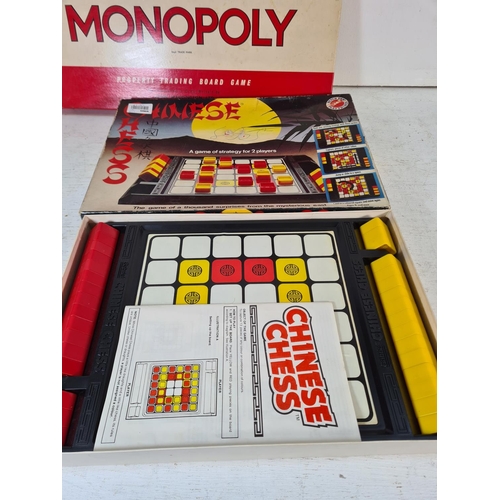 90 - A collection of assorted boxed toys and games to include Monopoly, Chinese chess, Cover Up, Take The... 