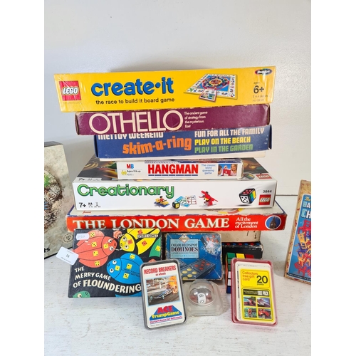 91 - A collection of assorted boxed toys and games to include The Balancing Chairs game, Hangman, Skim-a-... 