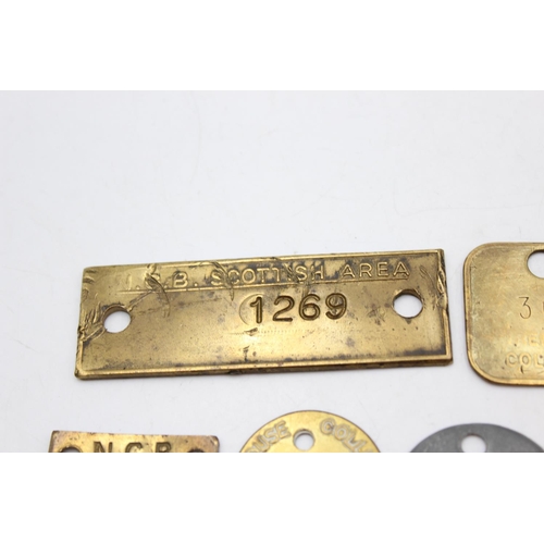 Twelve vintage brass miners and colliery pit check tags