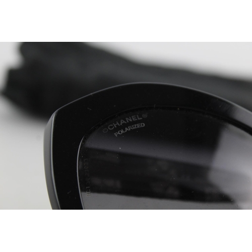 119 - A pair of black Chanel sunglasses with polarized lenses and dust bag